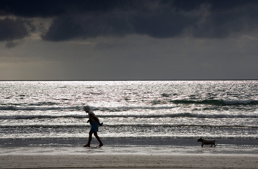Pensioner taking the dog for a walk on Rossbeigh Beach, Ring of Kerry, Ireland, Europe