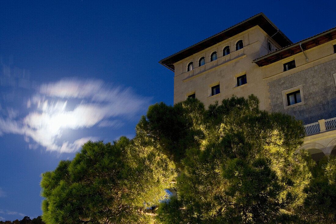 Hotel Maricel behind treetops at night, Palma, Majorca, Spain