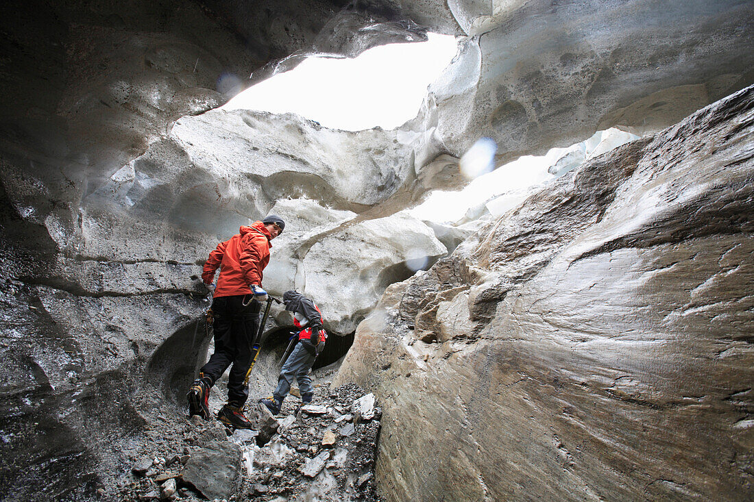 Two women inside a glacier cave, Brunegg Glacier, Canton of Valais, Switzerland, MR