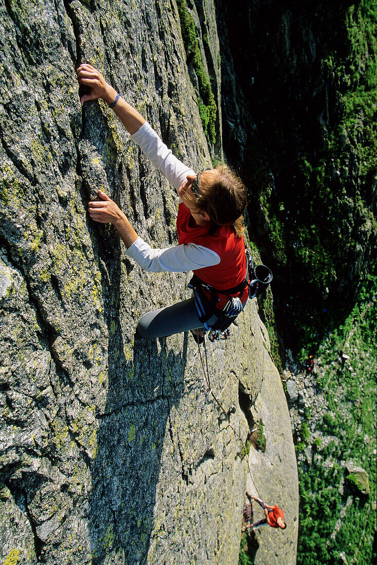 Young woman freeclimbing at rock, Bernese Oberland, Canton Uri, Switzerland, MR