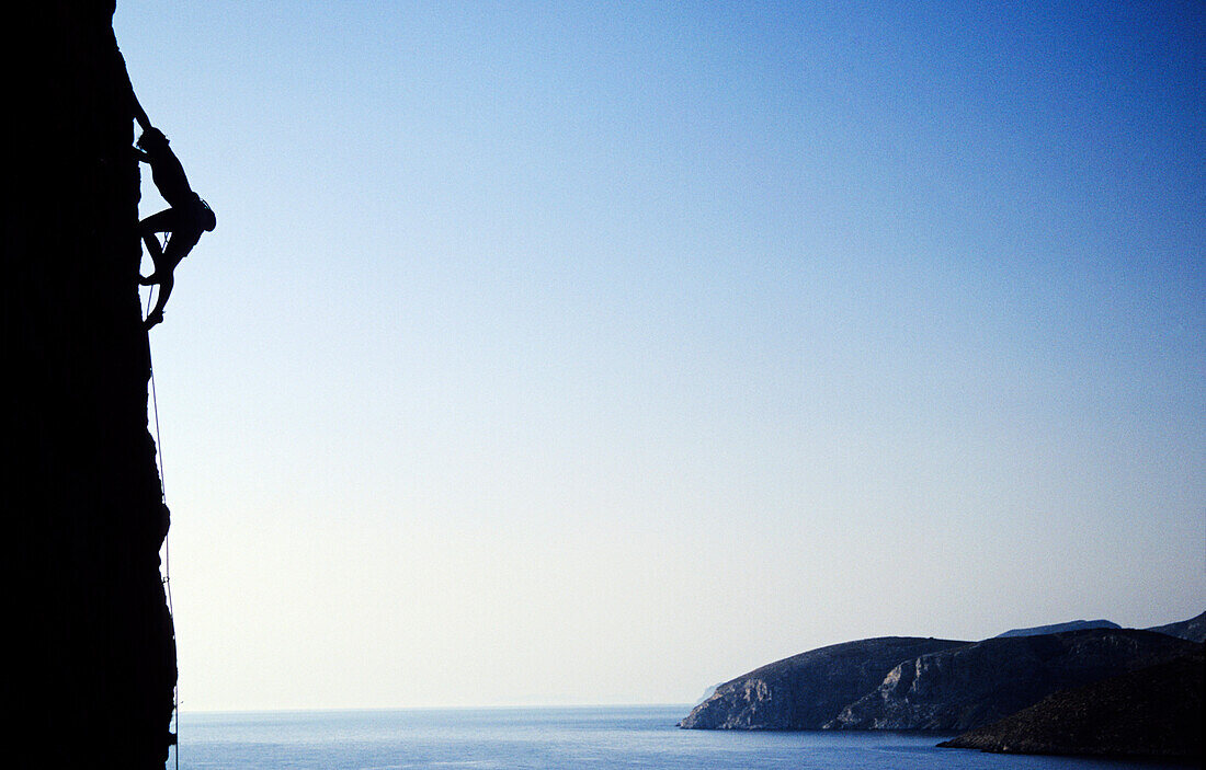 Young woman climbing at rock face over Aegean Sea, Kalymnos Island, Greece, MR