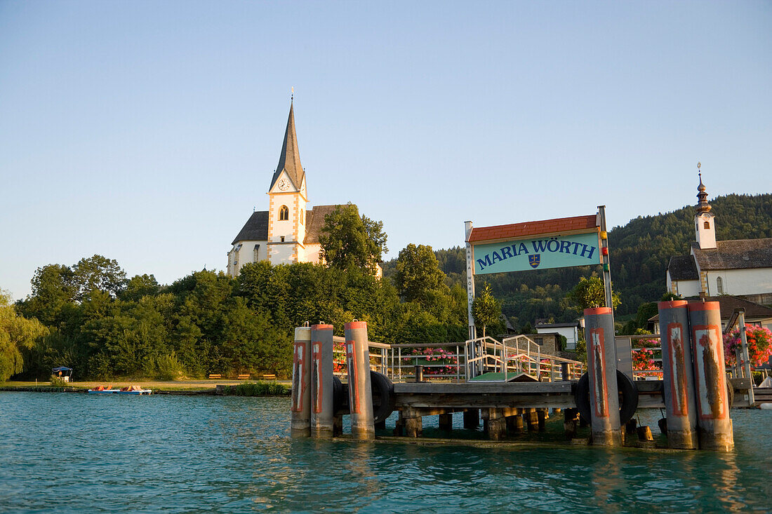 View over Woerthersee the largest lake in Carinthia to the parish church Maria Woerth, Carinthia, Austria