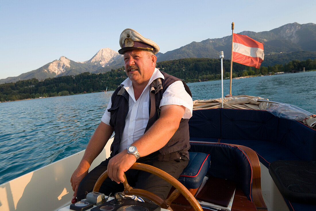 Skipper of a taxi boat service to the Inselhotel Faakersee, Lake Faak, Carinthia, Austria