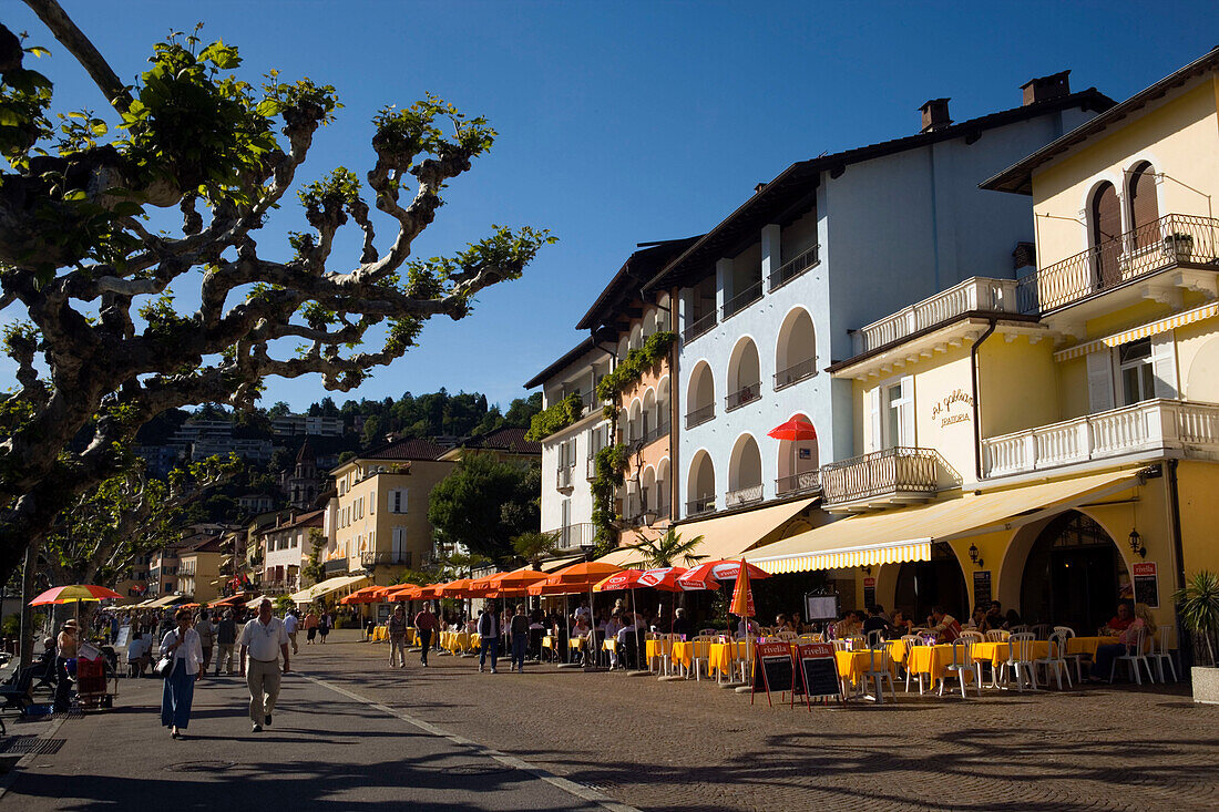 View along harbour promenade with pavement cafes, Ascona, Lago Maggiore, Ticino, Switzerland