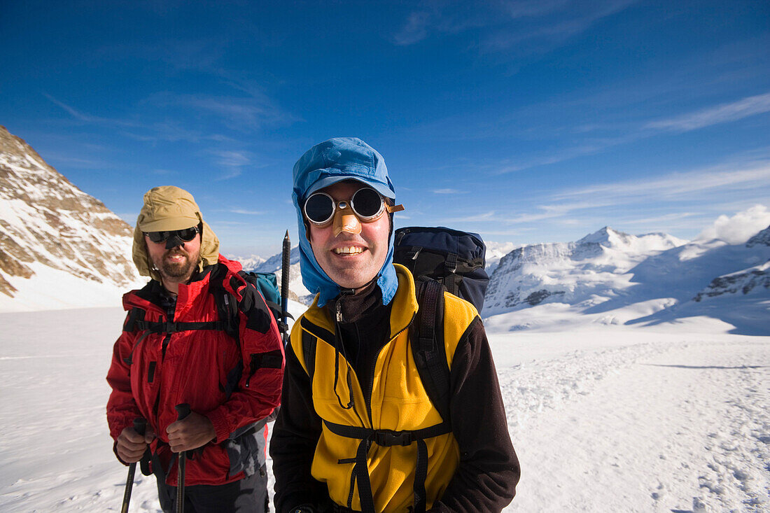 Two glacier hikers with snow googles, Jungfraufirn glacier, Bernese Highlands, Canton of Bern, Switzerland