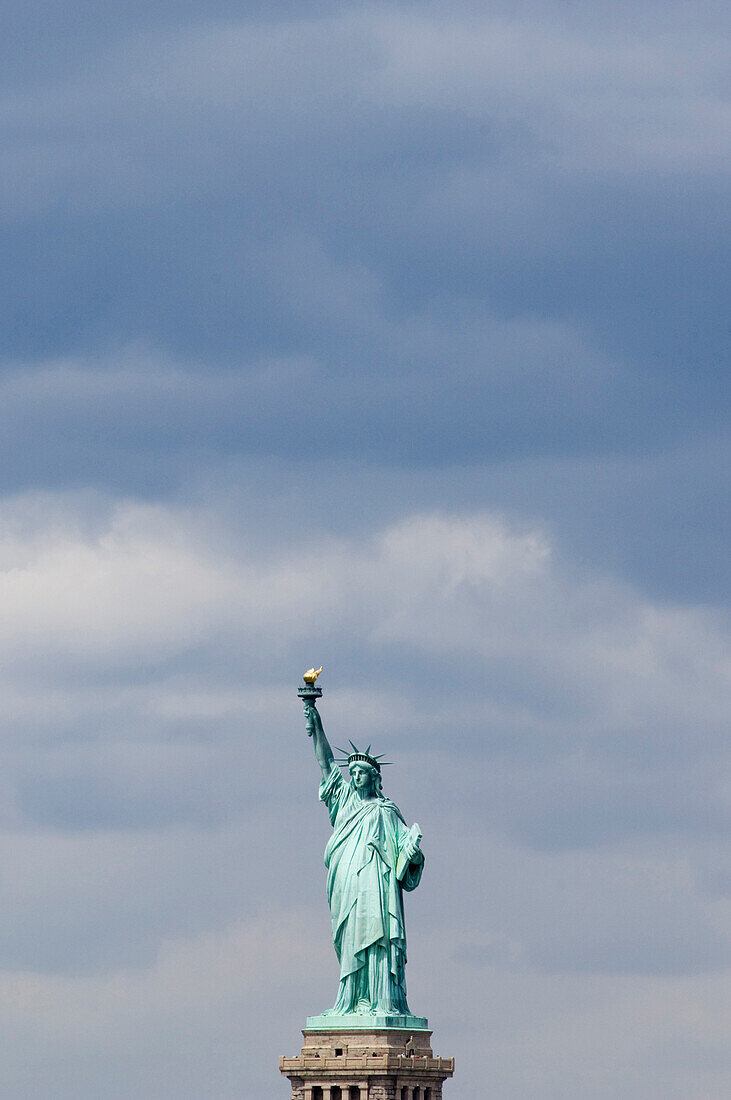 Statue of Liberty in front of cloudy sky, New York, USA