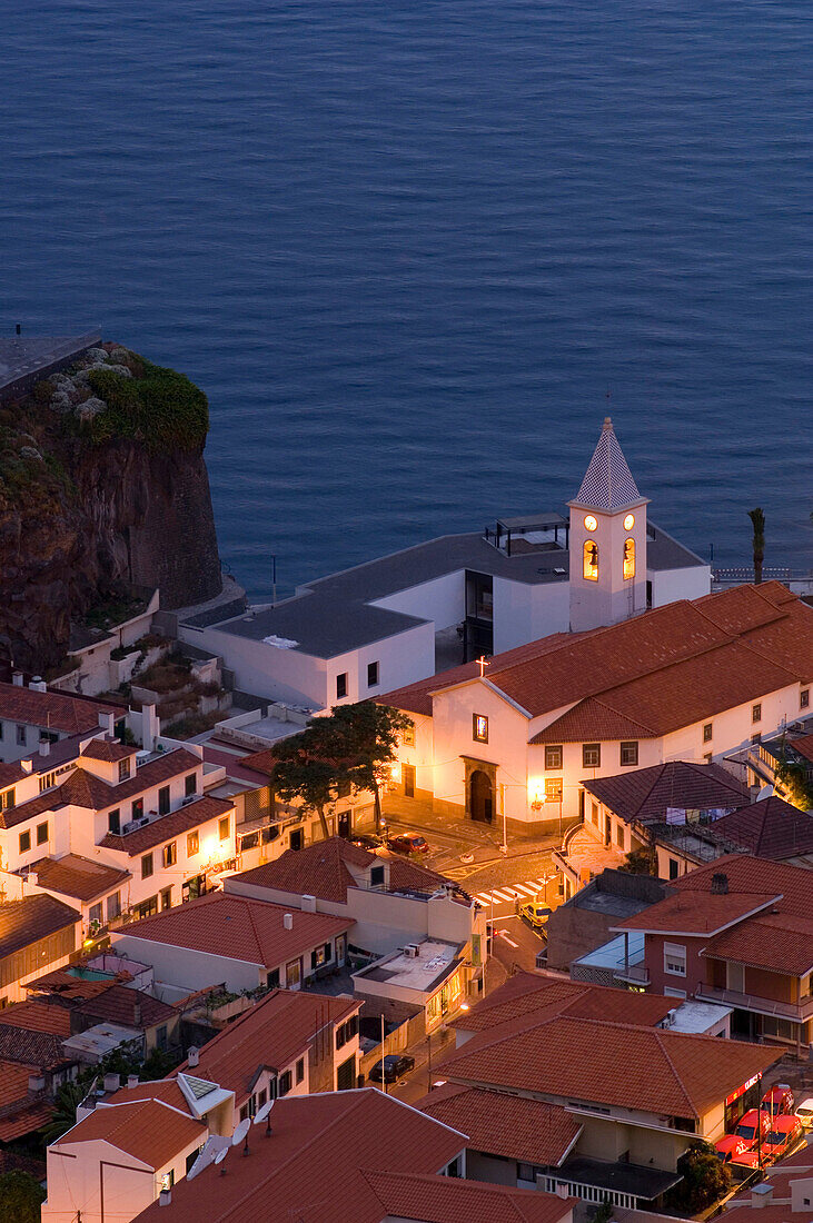 Houses and a church on the coast in the evening, Camara de Lobos, Madeira, Portugal