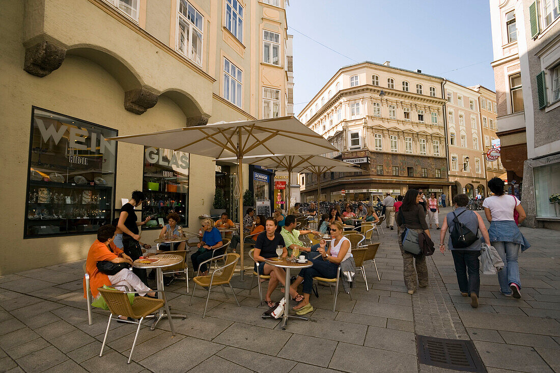 Women passing a pavement cafe, Salzburg, Salzburg, Austria, Since 1996 historic centre of the city part of the UNESCO World Heritage Site