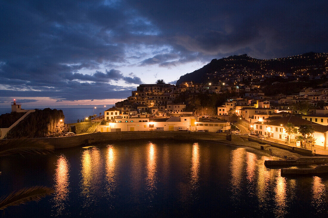 Illuminated houses at harbour in the evening, Camera de Lobos, Madeira, Portugal