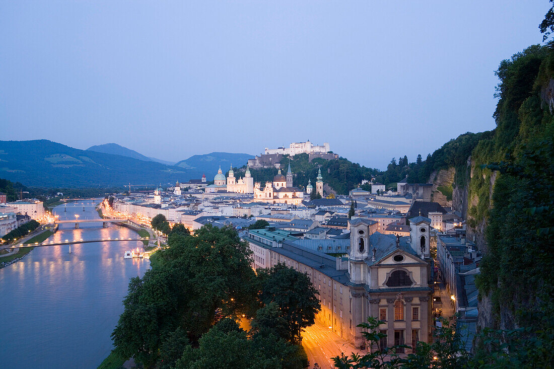 Panoramic view over Salzburg along the Salzach with Hohensalzburg Fortress, the largest fully preserved fortress in central Europe, Salzburg Cathedral, Franciscan Church, St. Peter's Archabbey, Collegiate Church, and St. Marcus Church in the evening, Salz