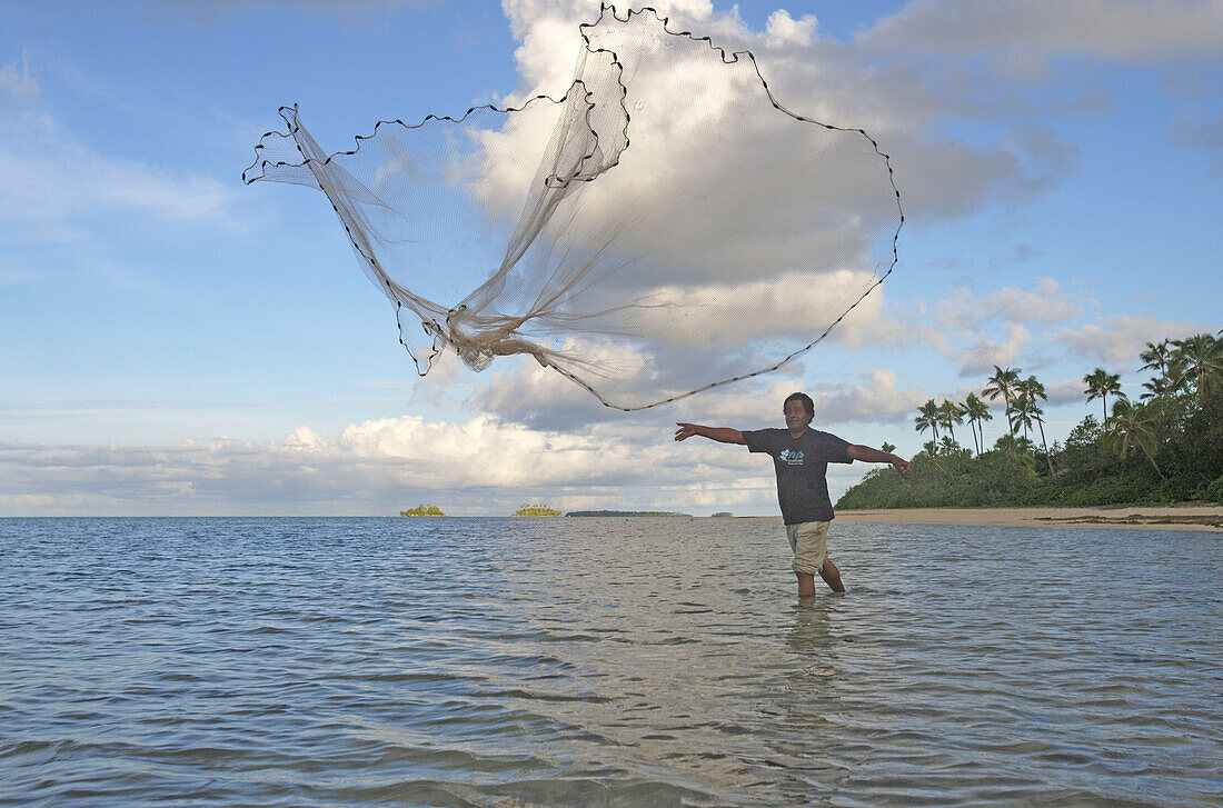 Fiherman throwing out fishnet, Fafa Island Resort, Tonga, South Seas