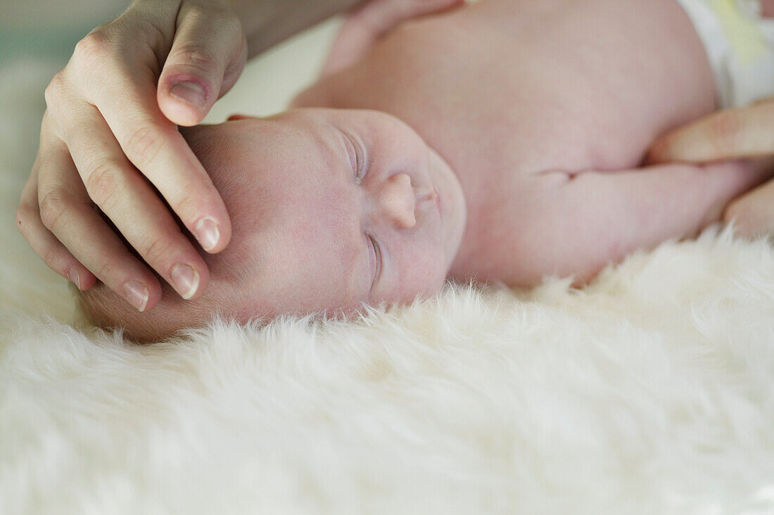 Mother touching sleeping baby