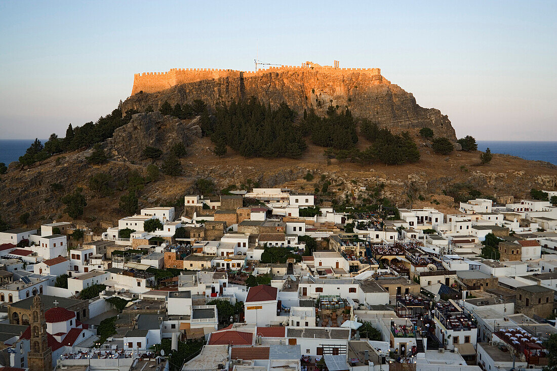 View over houses to hill with Acropolis, Lindos, Rhodes, Greece