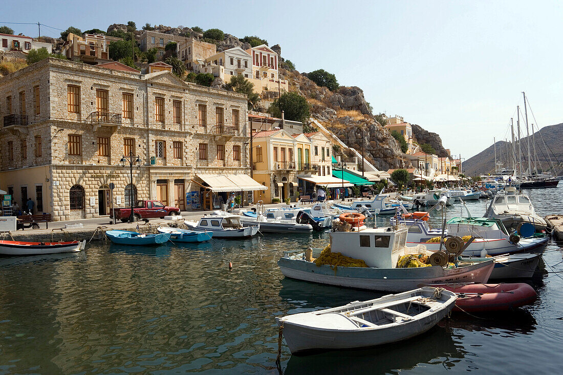 Fishing boats and rowboats anchoring in harbour Gialos, Simi, Symi Island, Greece