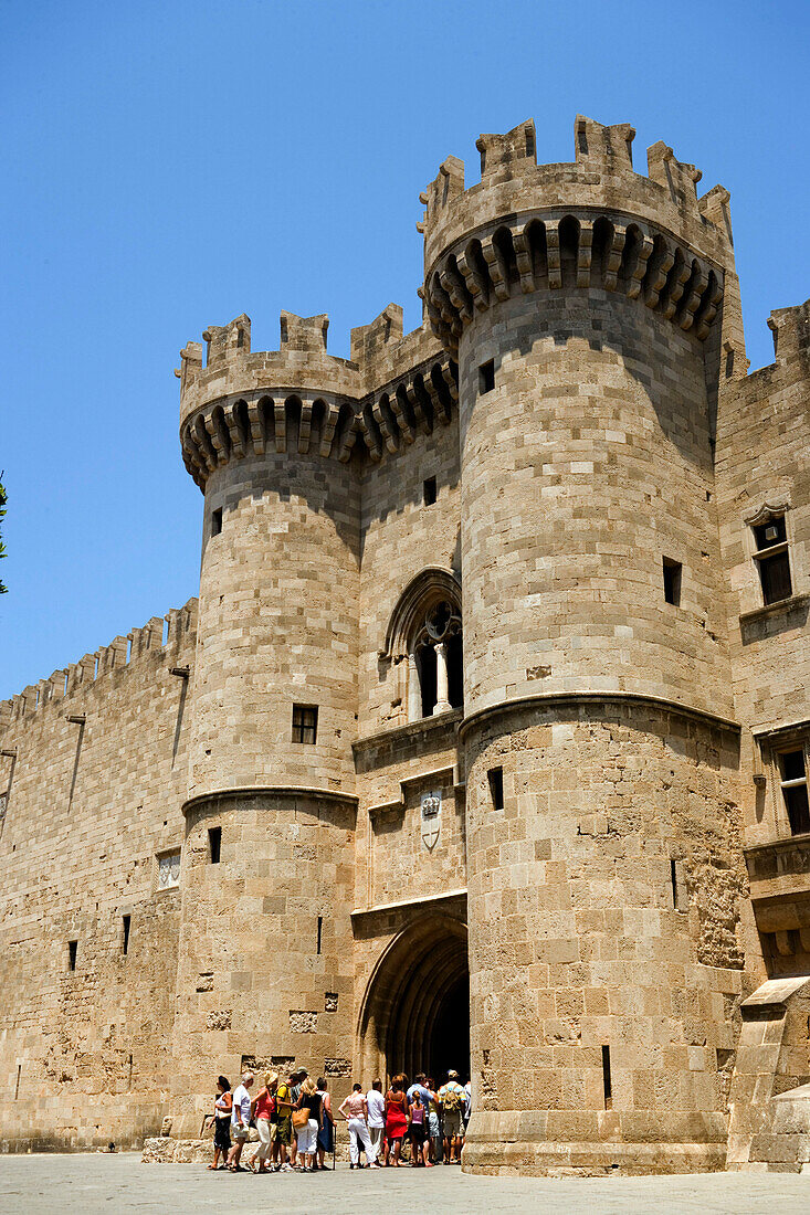 People entering Palace of the Grandmaster, built during  the 14th century, through the main entrance (Thalassini Gate), Rhodes Town, Rhodes, Greece, (Since 1988 part of the UNESCO World Heritage Site)