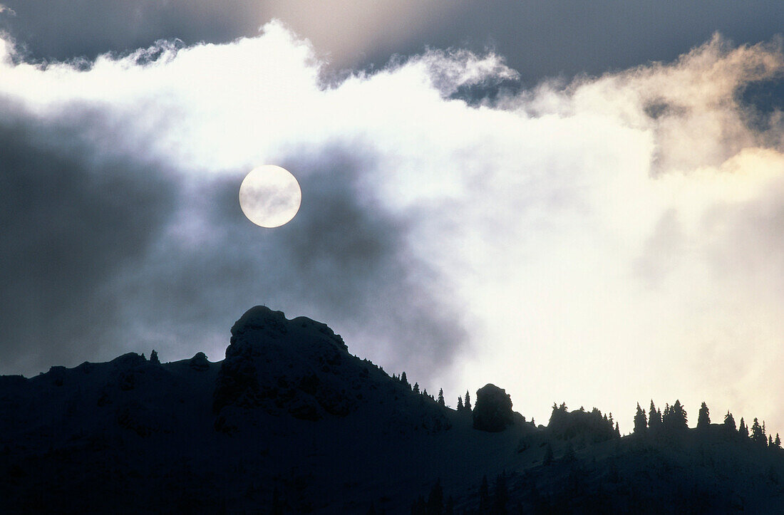 Clouds covering sun over mountain scenery, Vorderriß, Upper Bavaria, Bavaria, Germany