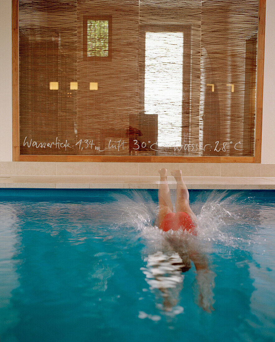 Woman jumping into a pool, Hotel Neuklostersee, Nakenstorf, Mecklenburg-Western Pomerania, Germeny, MR, PR