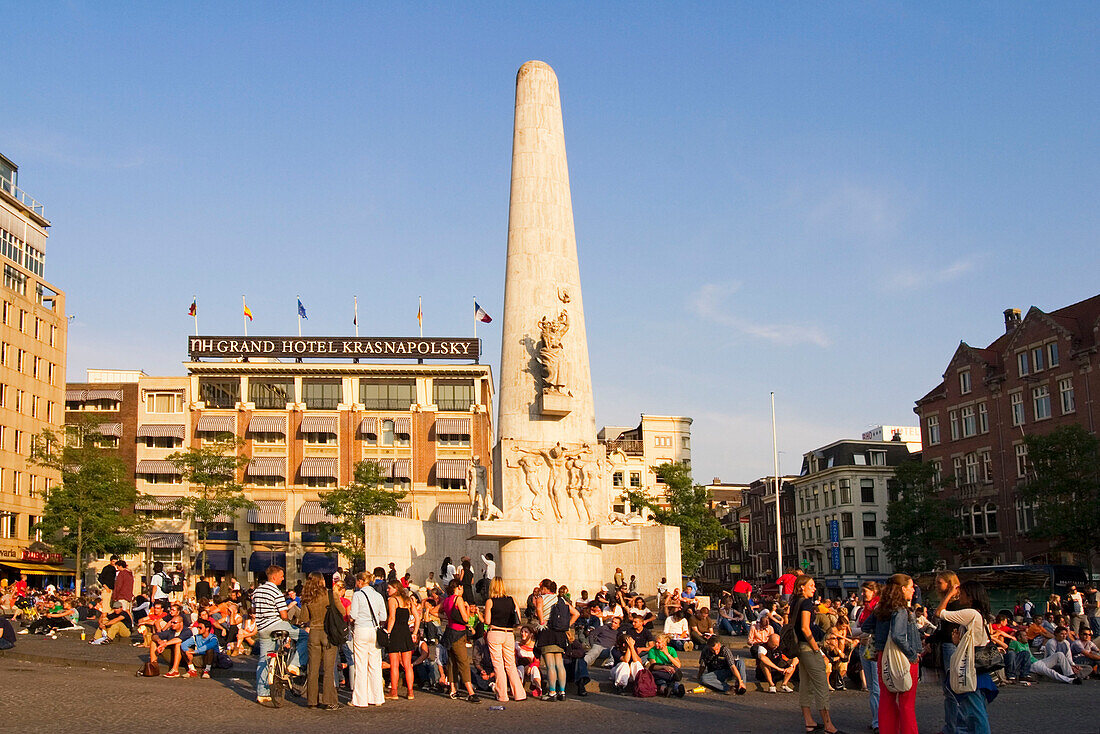 Amsterdam, Dam square at sunset people, background Grand Hotel Krasnapolky