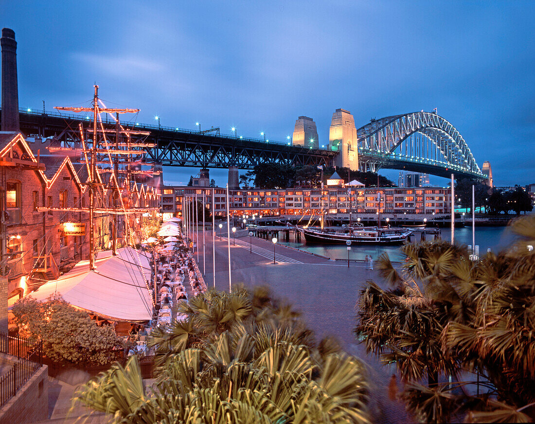 Restaurants in the evening, harbour bridge, Sydney, Australia