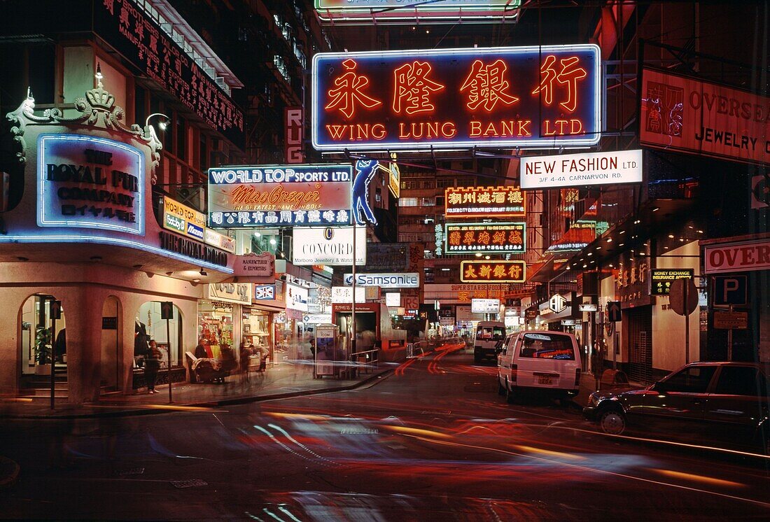 Neon lit roads with trams and traffic on Kowloon in Hong Kong