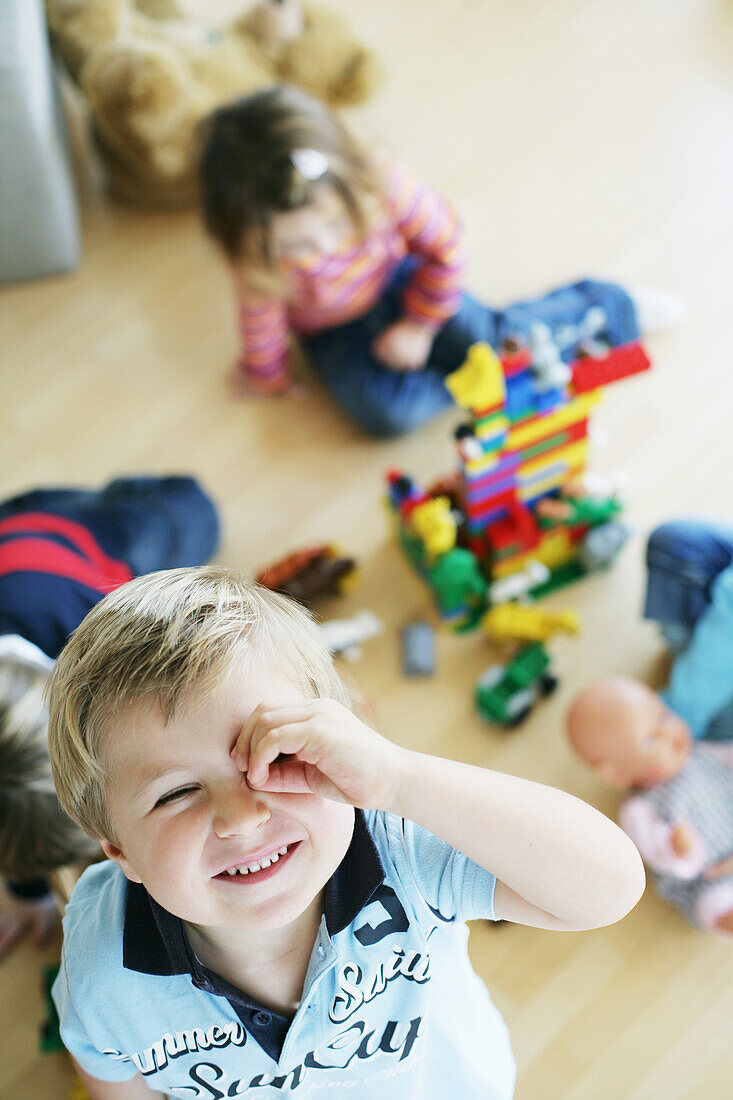 Children playing with plastic bricks and toys