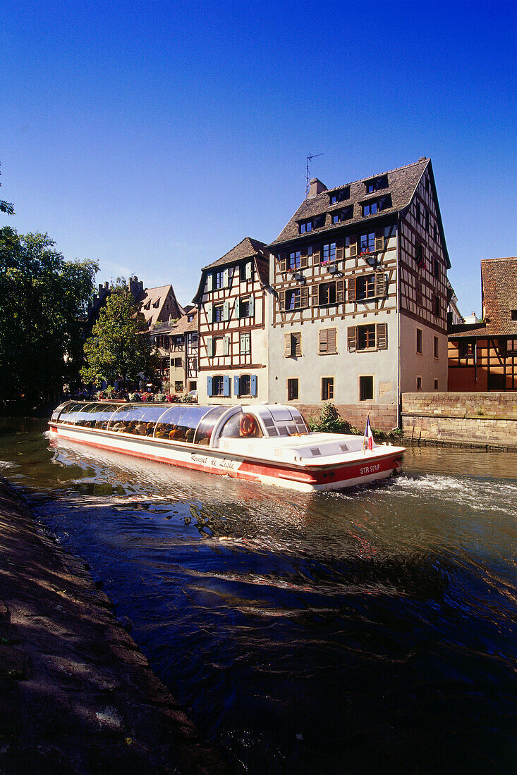 Excursion boat on anabranch of Ill river, half timbered houses at the district La Petite France, Strasbourg, Alsace, France, Europe