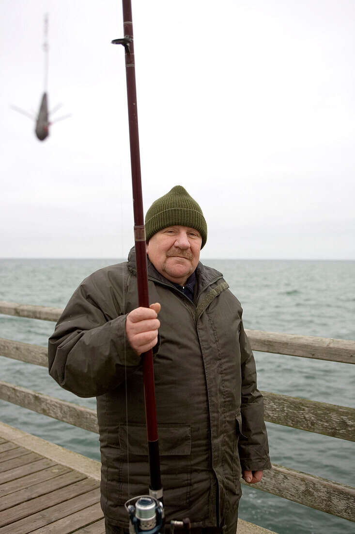 Mature man on pear at Baltic Sea, Mecklenburg-Western Pomerania, Germany