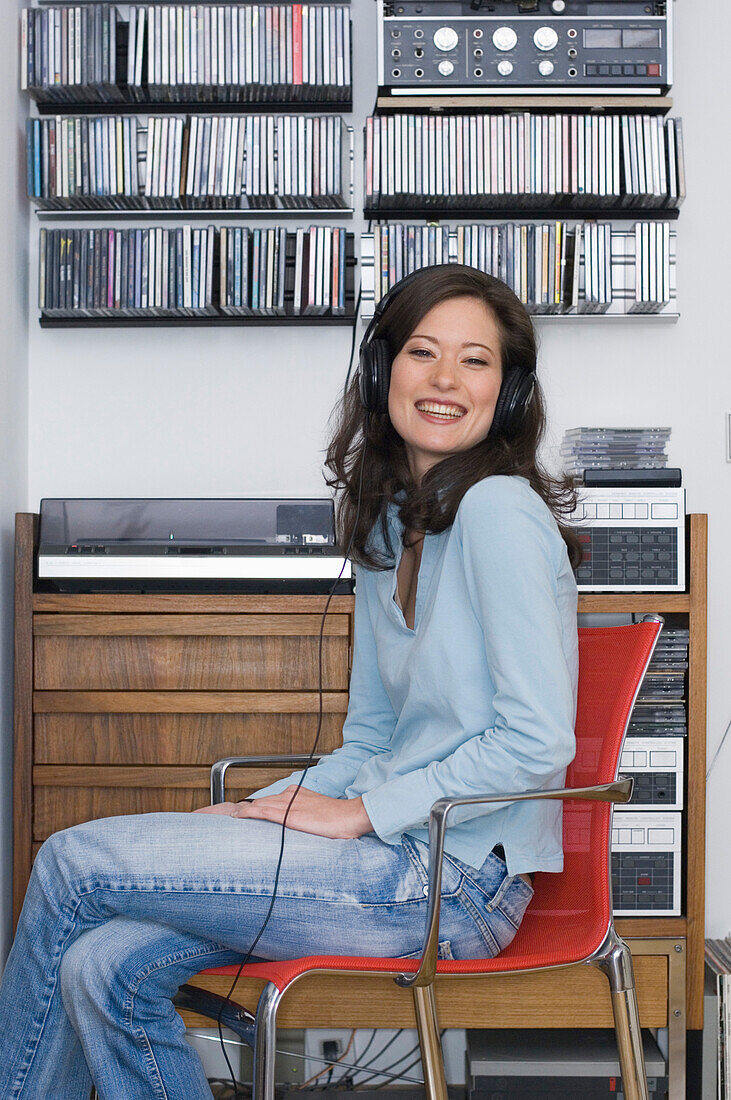 Young woman listening to music about earphones