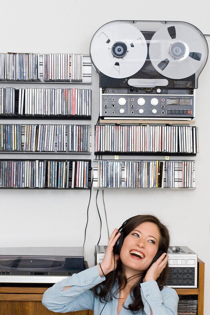 Young woman listening to music about earphones