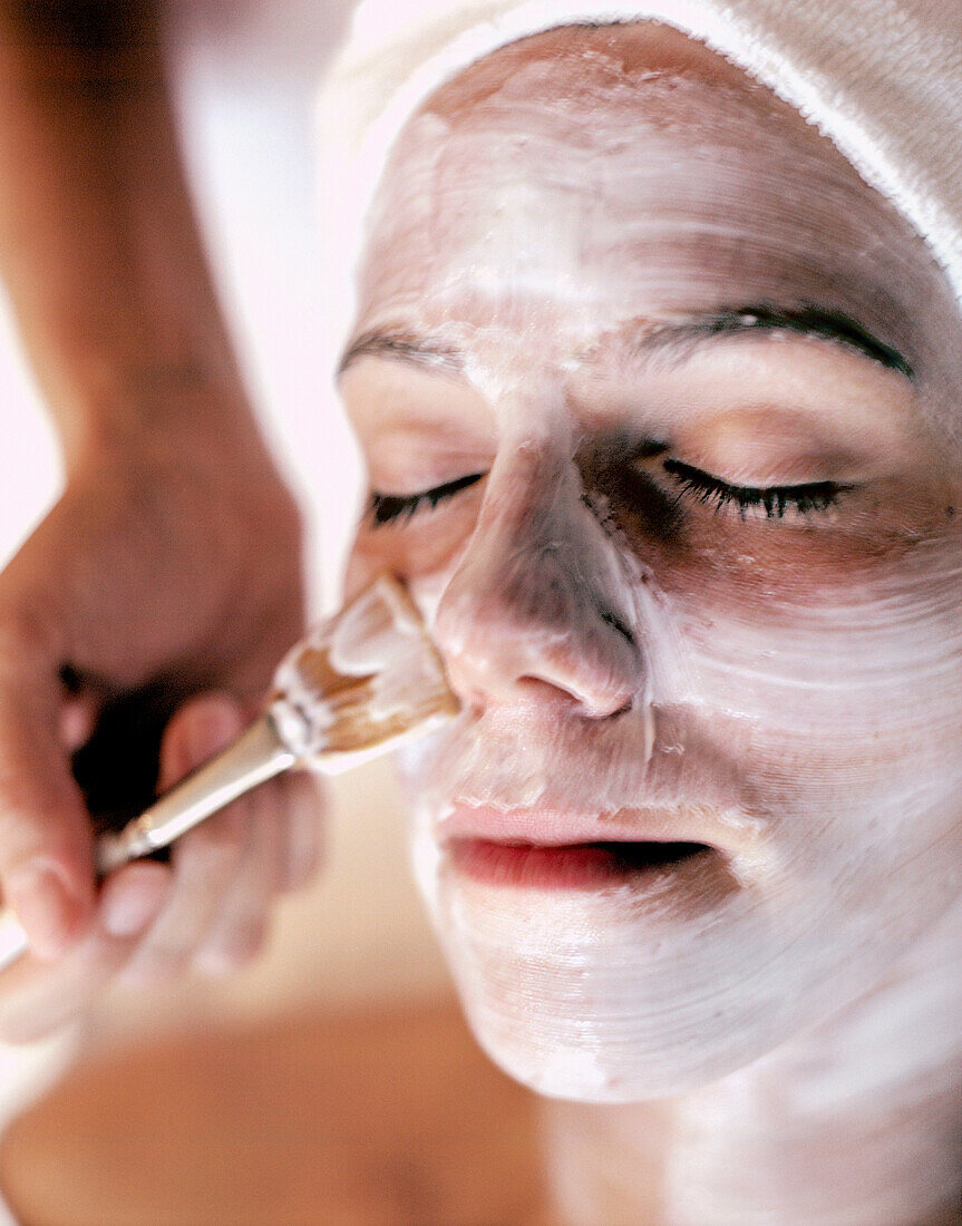 Woman receiving spa facial treatment