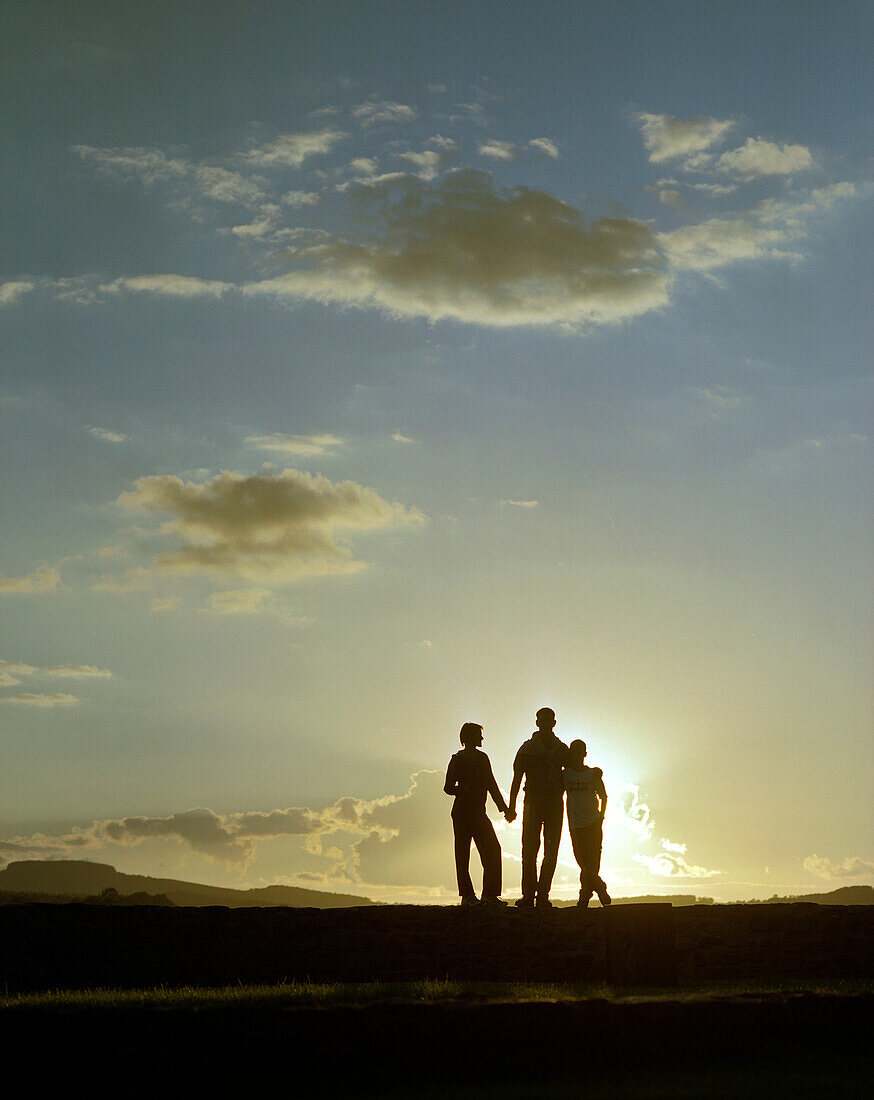 Family with son, walking in the sunset, near Hameln, Weserbergland, Lower Saxony, Germany