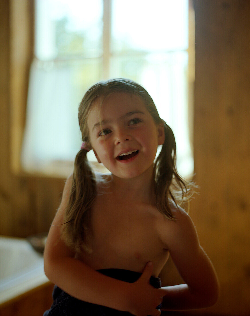 Wellness for children, girl wrapped in a bathtowel after wellness treatment, Bathroom, Wellness Hotel, Germany