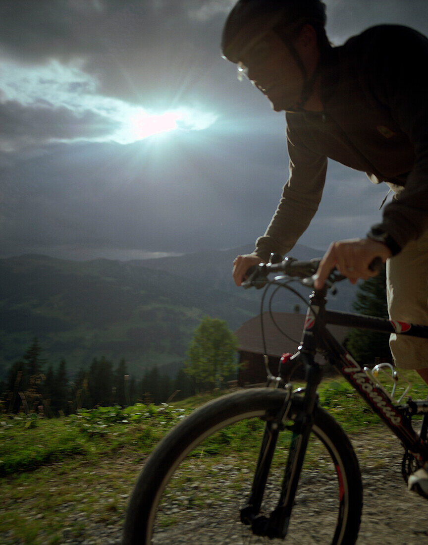 Mountainnbiker over Simmen Valley, near Lenk, Bernese Alps, Canton Bern, Switzerland
