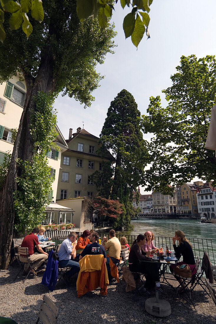 People sitting in open-air area of a restaurant at river Reuss, Mühlenplatz, Lucerne, Canton Lucerne, Switzerland