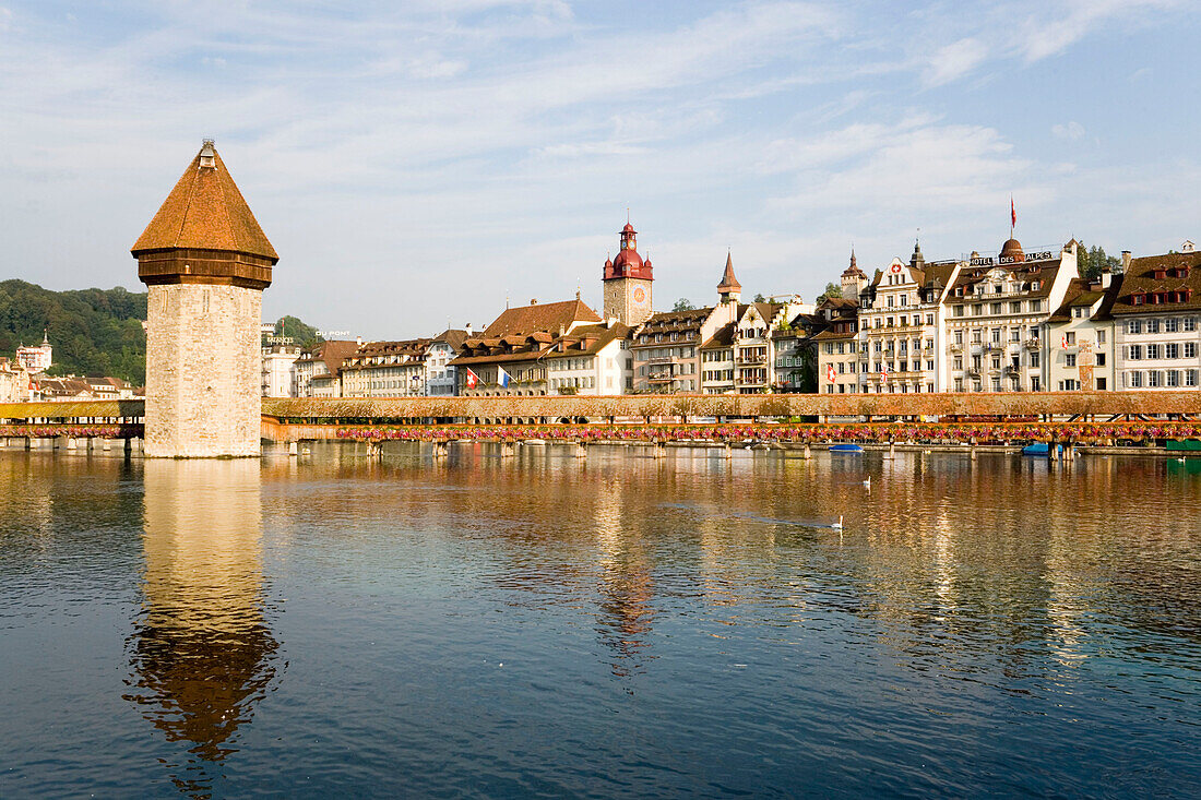 View over river Reuss with Kapellbrücke (chapel bridge, oldest covered bridge of Europe) and Wasserturm to houses at Rathausquai, Lucerne, Canton Lucerne, Switzerland