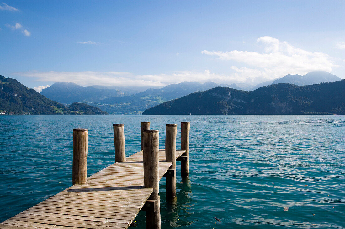 View from a wooden footbridge over Lake Lucerne with mountains in background, Weggis, Canton of Lucerne, Switzerland