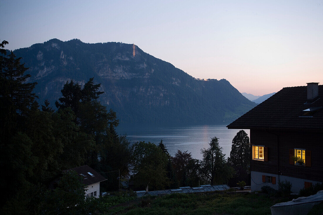 View along an illuminated house to Lake Lucerne in the evening, Weggis, Canton of Lucerne, Switzerland