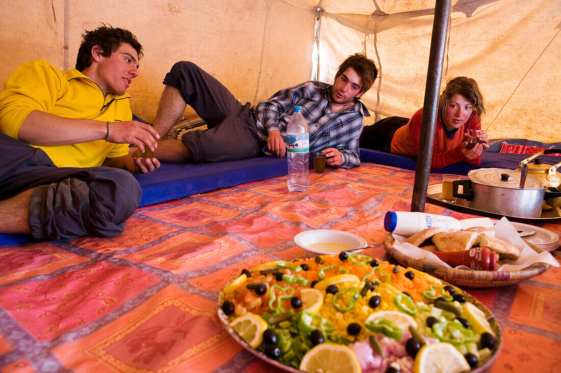 Trekkers having lunch in a Berber tent, Morocco, Atlas Mountains, Toubkal Region, North Africa