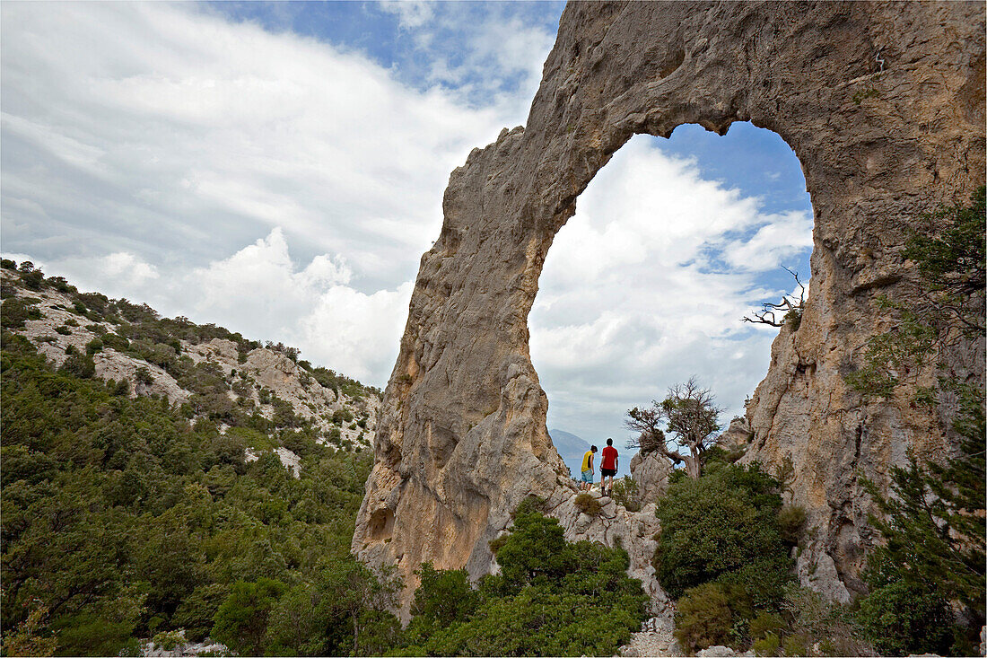Rock arch s'Architeddu Lupiru on the adventurous trekking Il Sentiereo Selvaggio Blu, Sardinia, Golfo di Orosei, Italy. , MR
