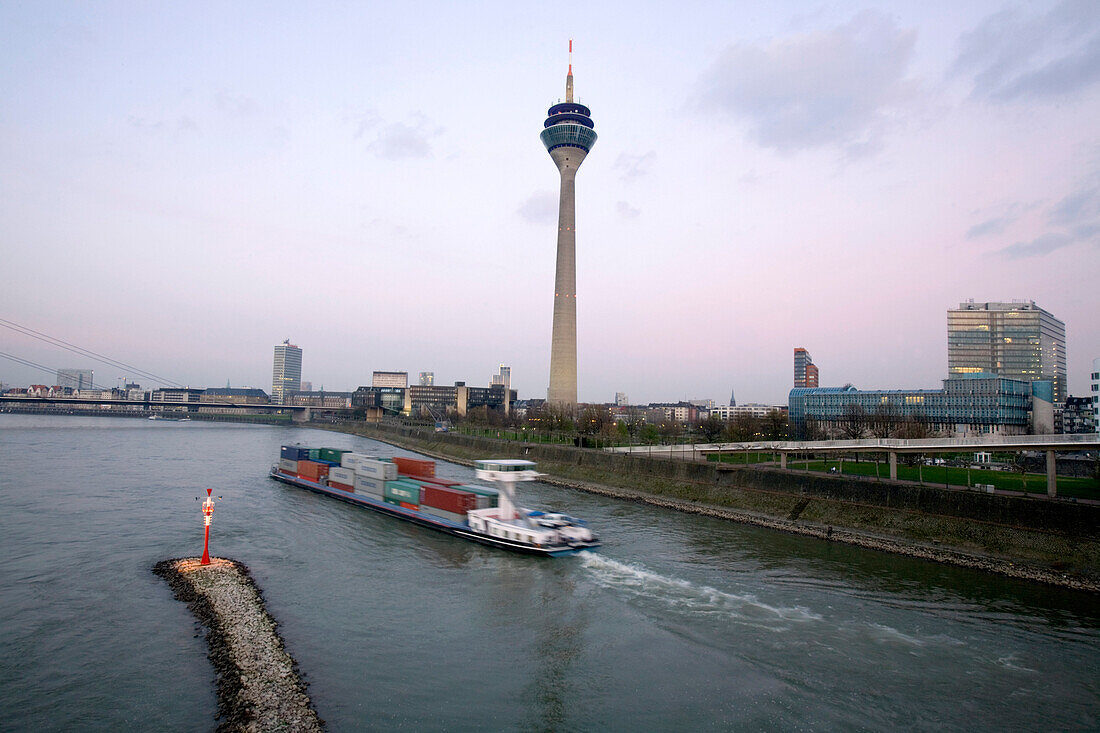 Passing container ship at the television tower, Rheinturm, with Düsseldorf skyline, Media Harbour, state capital of NRW, North-Rhine-Westphalia, Germany
