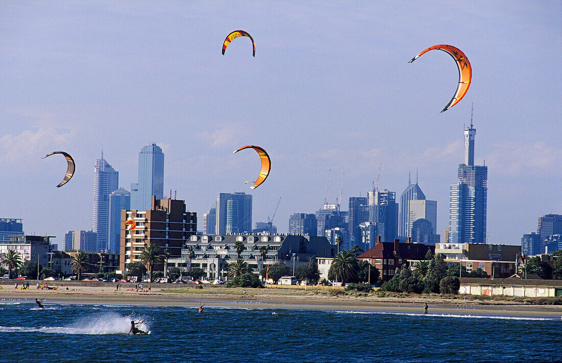 Kite surfing on St. Kilda beach in front of the skyline of downtown Melbourne, Victoria, Australia