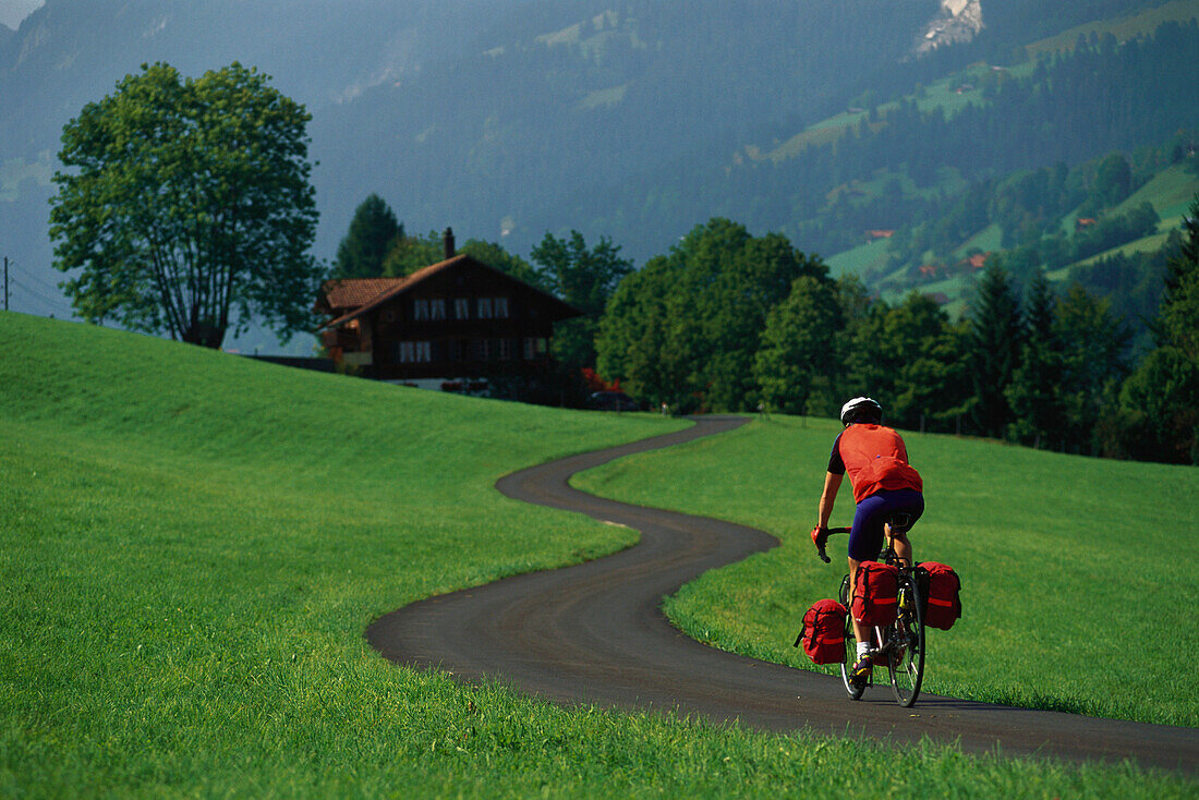 Man on a bicycle tour near Därstetten, Berne, Switzerland, Europe