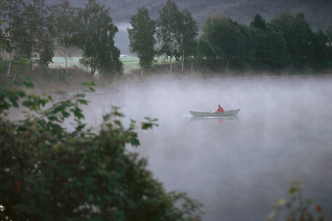 A fisherman in a boat on lake Stryn, Norway