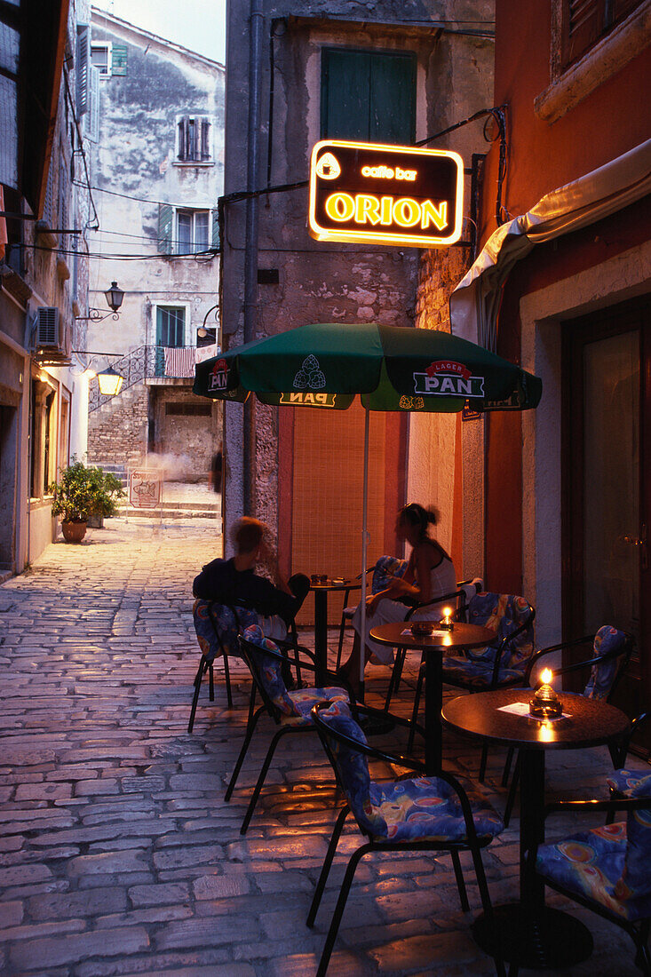 A couple sitting outside a street cafe in Roviny, Istria, Croatia