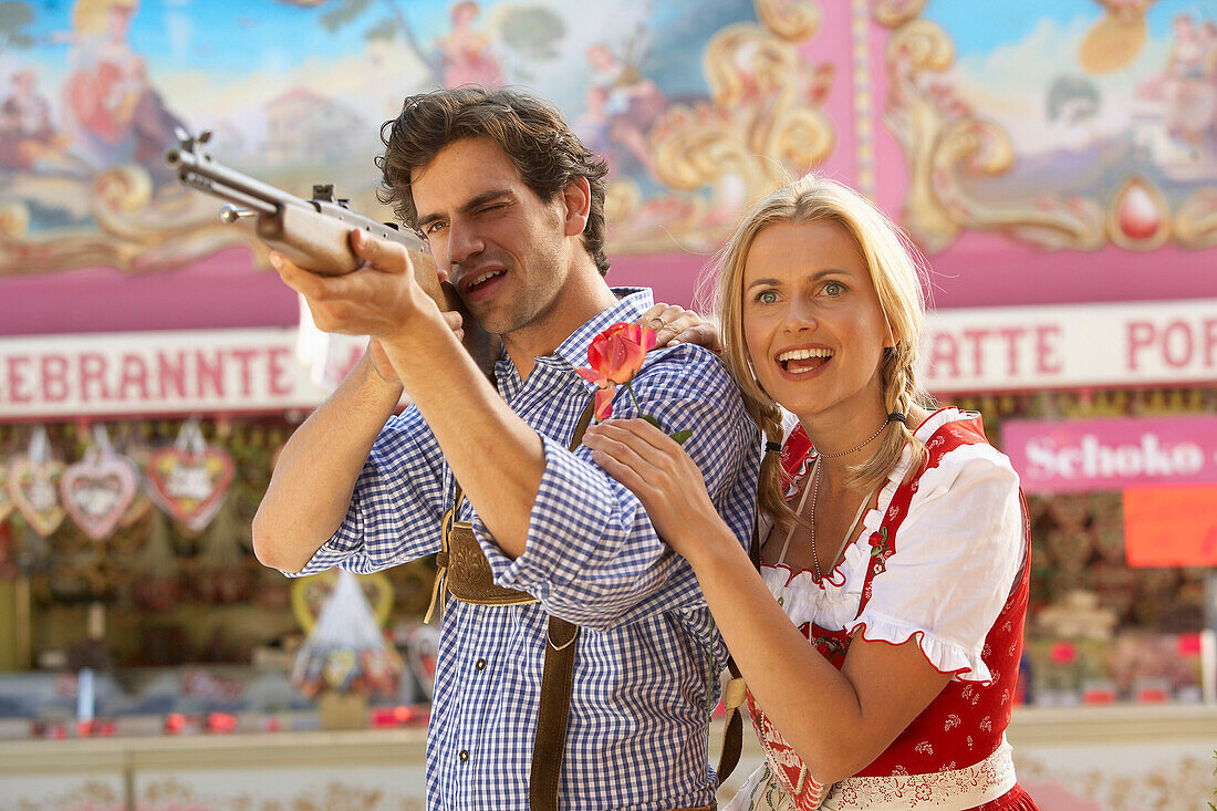 Couple at shooting gallery, Oktoberfest, Munich, Bavaria, Germany