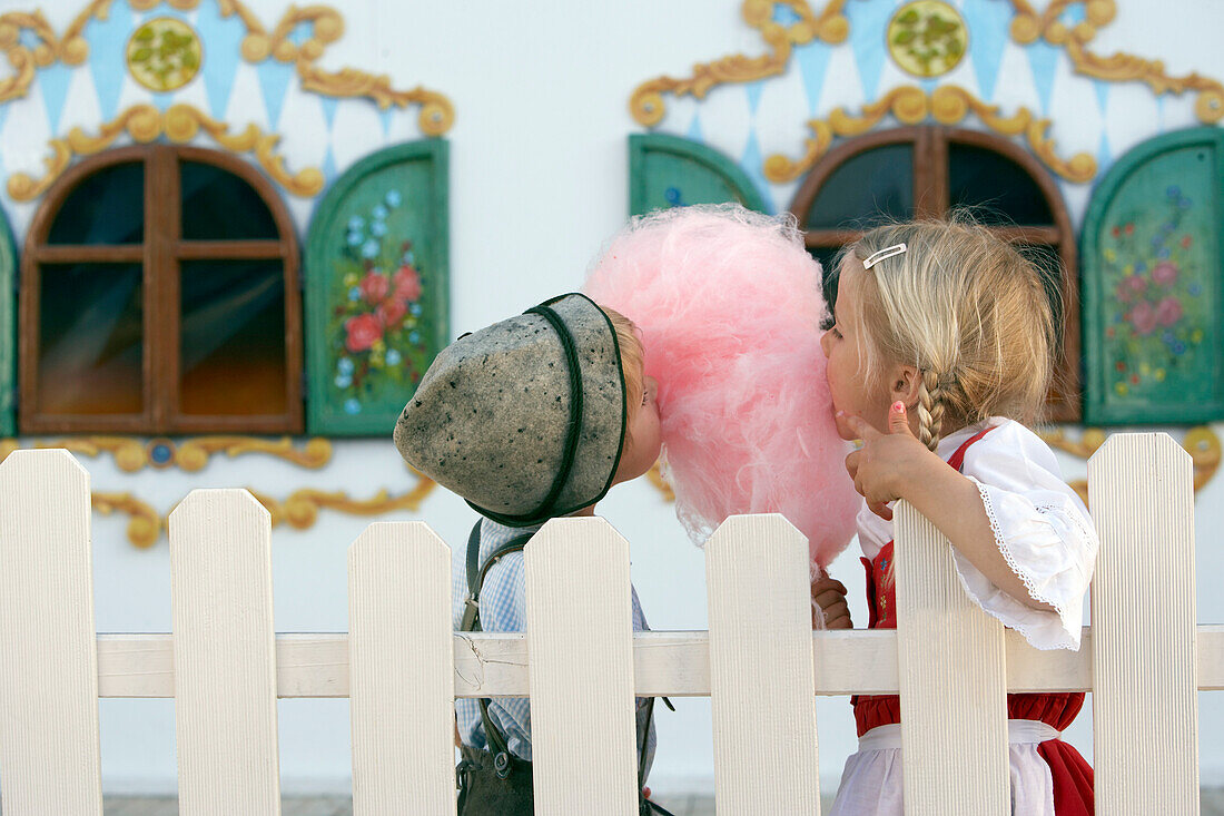 Children (3-5 years) eating pink cotton candy