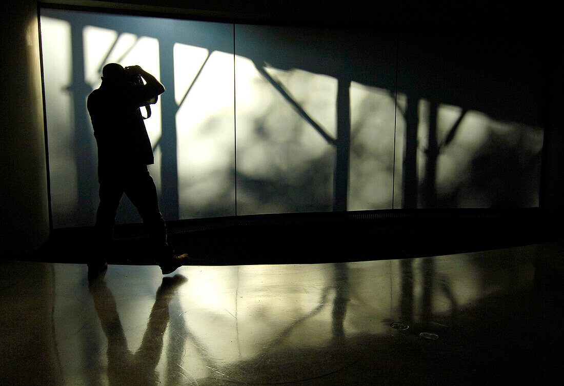 A photographer taking photographs in the Guggenheim Museum, New York City, New York, USA