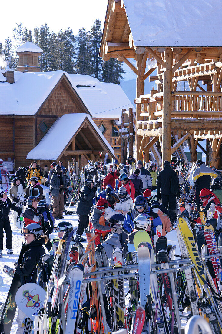 Skiers and snowboarders waiting at the base station at Lake Louise ski resort, Lake Louise, Alberta, Canada