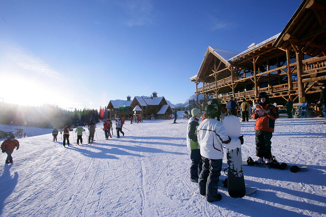 Skiers and snowboarders waiting at the base station at Lake Louise ski resort, Lake Louise, Alberta, Canada
