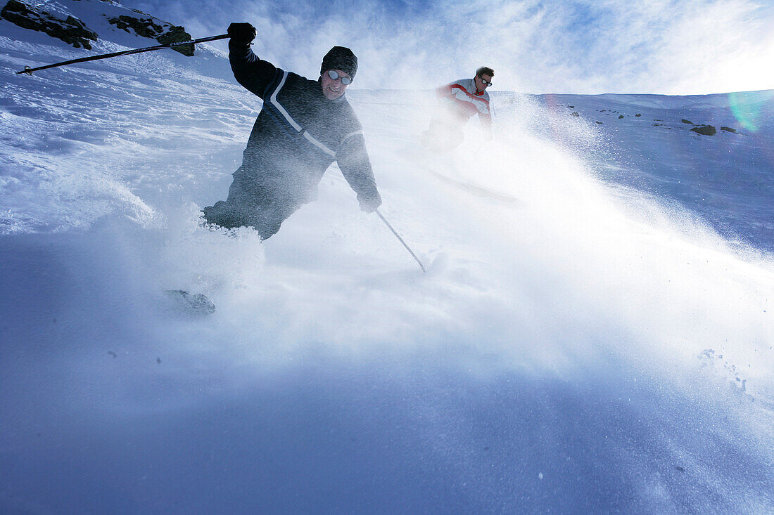 Two men skiing down a slope, Stuben, St Anton, Tyrol, Austria